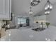 Bright kitchen island and wet bar area with pendant lighting and open to sunroom with lots of natural light at 5351 Abbington Ave, Plainfield, IN 46168
