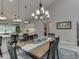 Modern open concept with view from kitchen to dining room, accentuating pendant lighting and bar seating at 5351 Abbington Ave, Plainfield, IN 46168