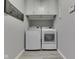 Convenient laundry room with modern washer, dryer, and built-in cabinets for storage at 5351 Abbington Ave, Plainfield, IN 46168