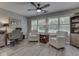 Comfortable living room featuring two chairs, a ceiling fan, and abundant natural light at 5351 Abbington Ave, Plainfield, IN 46168
