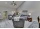 Open concept living room with vaulted ceilings, wood plank flooring, and comfortable seating at 5351 Abbington Ave, Plainfield, IN 46168