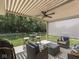 Inviting outdoor patio with comfortable seating, a fan, and a retractable sun shade overlooking the lawn at 5351 Abbington Ave, Plainfield, IN 46168
