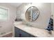 Well-lit bathroom featuring modern vanity, granite countertop, updated fixtures, and stylish decor at 5625 Winston Dr, Indianapolis, IN 46226