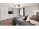 This cozy bedroom includes built-in cabinets and drawers, a ceiling fan, and a window for plenty of natural light at 5625 Winston Dr, Indianapolis, IN 46226