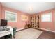 Inviting bedroom with vibrant wall color, lots of natural light, and hardwood floors, perfect for a study at 5625 Winston Dr, Indianapolis, IN 46226
