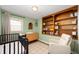 Charming Bedroom with built-in shelving, light green walls, and lots of space for a growing Gathering at 5625 Winston Dr, Indianapolis, IN 46226