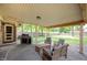 Inviting covered patio with ample seating and a built-in grill, ideal for outdoor gatherings at 5625 Winston Dr, Indianapolis, IN 46226