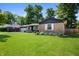 Charming single-story home with brick facade, well-maintained lawn, and lush landscaping at 5625 Winston Dr, Indianapolis, IN 46226
