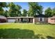 Charming single-Gathering home with brick and blue siding plus a manicured lawn and landscaping at 5625 Winston Dr, Indianapolis, IN 46226