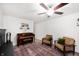 Bright living room featuring a hardwood floor, piano, fireplace, ceiling fan, and natural lighting at 5625 Winston Dr, Indianapolis, IN 46226