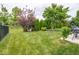Spacious backyard featuring a well-manicured lawn and defined planting areas, ideal for outdoor enjoyment at 5684 Autumn Trl, Brownsburg, IN 46112