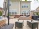 Inviting backyard patio area featuring comfortable seating, fire pit, and outdoor umbrella at 5684 Autumn Trl, Brownsburg, IN 46112
