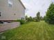 Well-maintained backyard with lush green grass, defined lawn and landscape features at 5684 Autumn Trl, Brownsburg, IN 46112