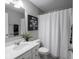 Bright bathroom with white vanity, flower art and shower and tub combination at 5684 Autumn Trl, Brownsburg, IN 46112