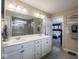 Bright bathroom with double sink vanity, gray tile floors, and glass enclosed shower at 5684 Autumn Trl, Brownsburg, IN 46112