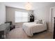 Neutral bedroom featuring a comfy bed, a soft chair and a large window for lots of natural light at 5684 Autumn Trl, Brownsburg, IN 46112