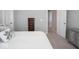 Well-lit bedroom with light colored walls and carpet featuring a dark wood bedside table at 5684 Autumn Trl, Brownsburg, IN 46112