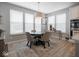 Cozy dining area with a round table, comfortable chairs, and plenty of natural light at 5684 Autumn Trl, Brownsburg, IN 46112