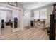 Inviting foyer with wood flooring and adjacent home office visible through glass doors at 5684 Autumn Trl, Brownsburg, IN 46112