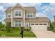 Charming two-story home with a well-manicured lawn and a two-car garage at 5684 Autumn Trl, Brownsburg, IN 46112