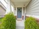 Inviting front porch with a 'Welcome' sign and decorative wreath on the front door at 5684 Autumn Trl, Brownsburg, IN 46112
