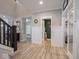 Open hallway with hardwood floors leading to various rooms in the home at 5684 Autumn Trl, Brownsburg, IN 46112
