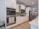 Modern kitchen design showcasing stainless steel appliances and sleek white cabinetry for a contemporary look at 5684 Autumn Trl, Brownsburg, IN 46112