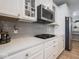Close-up of the kitchen area featuring stainless steel appliances and quartz countertops with a gray backsplash at 5684 Autumn Trl, Brownsburg, IN 46112