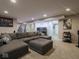 Spacious living room with large sectional sofa and an entertainment center, perfect for relaxation and entertainment at 5684 Autumn Trl, Brownsburg, IN 46112