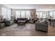 Spacious living room with large windows, plush seating, and stylish decor at 5684 Autumn Trl, Brownsburg, IN 46112
