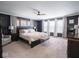Spacious main bedroom features dark blue walls, carpet, and natural light from multiple windows at 5684 Autumn Trl, Brownsburg, IN 46112