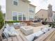 Large stone patio with built-in seating, offering an inviting outdoor living space with a fire pit at 5684 Autumn Trl, Brownsburg, IN 46112