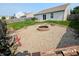 Cozy backyard with gravel firepit, woodpile, and wooden fence providing a private outdoor retreat at 581 Grassy Bend Dr, Greenwood, IN 46143