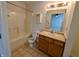 Bright bathroom features a shower-tub combo, toilet, and a single sink vanity with tile flooring at 581 Grassy Bend Dr, Greenwood, IN 46143