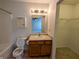 Bathroom features a shower-tub combo, toilet, and a single sink vanity with access to bedroom at 581 Grassy Bend Dr, Greenwood, IN 46143