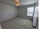 A bright bedroom features carpet flooring, a ceiling fan, and a window at 581 Grassy Bend Dr, Greenwood, IN 46143