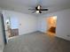 Comfortable bedroom featuring plush carpeting, a ceiling fan, and access to an en-suite bathroom at 581 Grassy Bend Dr, Greenwood, IN 46143
