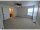 Cozy bedroom features plush carpeting, a ceiling fan, and natural light at 581 Grassy Bend Dr, Greenwood, IN 46143