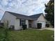 A well maintained single-story home with blue shutters, a 2-car garage, and inviting curb appeal at 581 Grassy Bend Dr, Greenwood, IN 46143