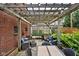 Cozy backyard patio featuring a pergola, brick accents, and comfortable seating area at 6280 Washington Blvd, Indianapolis, IN 46220