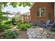Stone patio with comfortable seating and lush greenery, creating a private and relaxing outdoor space at 6280 Washington Blvd, Indianapolis, IN 46220