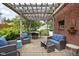Inviting backyard patio with pergola, stone pavers, and wicker furniture set at 6280 Washington Blvd, Indianapolis, IN 46220