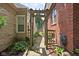 Pathway that divides a brick building with a stone building surrounded by greenery at 6280 Washington Blvd, Indianapolis, IN 46220