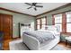 Bedroom featuring hardwood floors, comfortable bed, and modern ceiling fan at 6280 Washington Blvd, Indianapolis, IN 46220