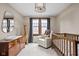Well-appointed Bedroom with a comfy white armchair, crib, and plush rug at 6280 Washington Blvd, Indianapolis, IN 46220