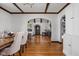 Dining room featuring hardwood floors with views of the living room and built-in storage at 6280 Washington Blvd, Indianapolis, IN 46220