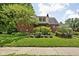 Beautiful brick home with lush green lawn and mature trees at 6280 Washington Blvd, Indianapolis, IN 46220