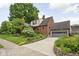 Charming two-story brick home with manicured landscaping and attached garage at 6280 Washington Blvd, Indianapolis, IN 46220