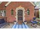 Charming front porch featuring a welcome mat and potted flowers leading to the front door at 6280 Washington Blvd, Indianapolis, IN 46220