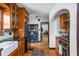 Open kitchen with stainless steel appliances, custom cabinets, and hardwood floors at 6280 Washington Blvd, Indianapolis, IN 46220